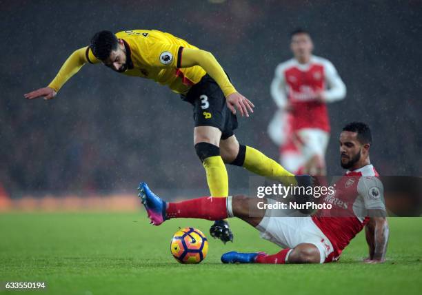 Arsenal's Theo Walcott holds of Watford's Miguel Angel Britos during the Premier League match between Arsenal and Watford at The Emirates , London on...