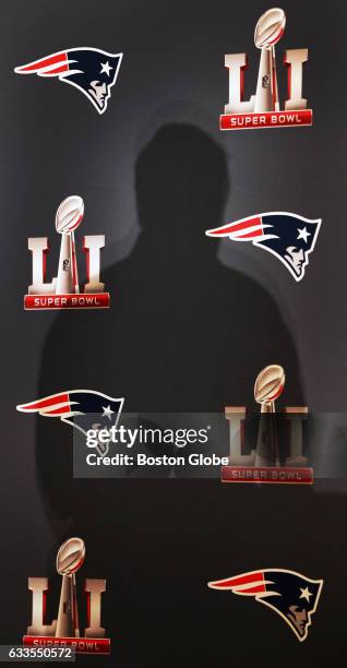 The shadow of New England Patriots head coach Bill Belichick is cast on the backdrop behind him as he takes questions from the media.The New England...