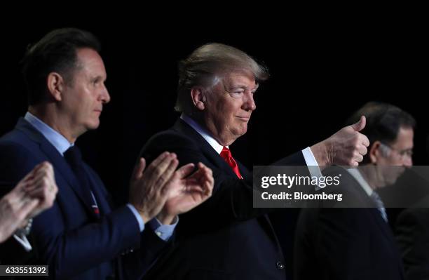 President Donald Trump, center, gives a thumbs up as Jordan's King Abdullah II, not pictured, is introduced during the National Prayer Breakfast in...