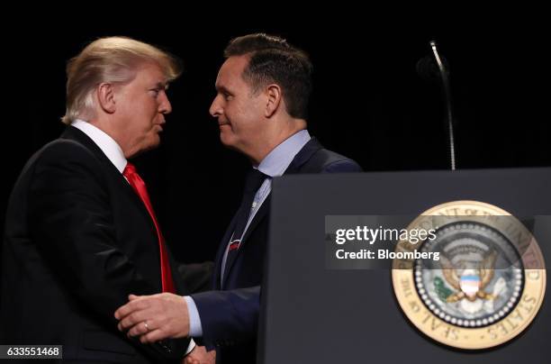 President Donald Trump, left, shakes hands with Television Producer Mark Burnett after being introduced during the National Prayer Breakfast in...