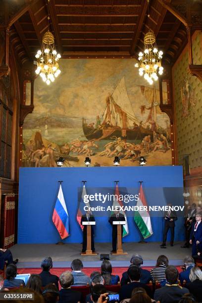 Russian President Vladimir Putin and Hungarian Prime Minister Viktor Orban give a joint press conference at the parliament building in Budapest on...