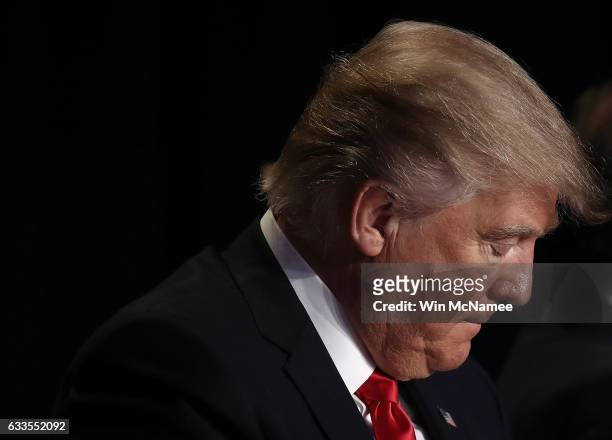 President Donald Trump bows his head in prayer while attending the National Prayer Breakfast February 2, 2017 in Washington, DC. Every U.S. President...
