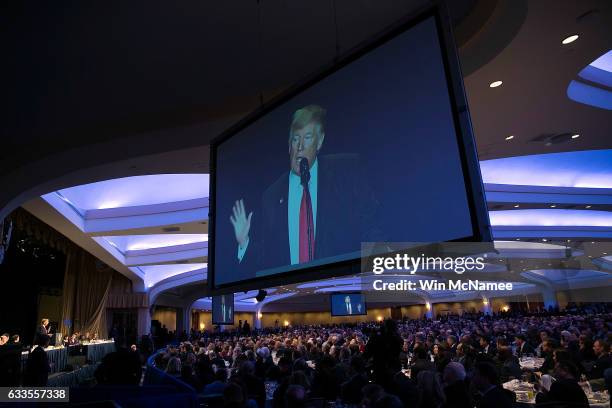 Attendees listen listen as U.S. President Donald Trump delivers remarks at the National Prayer Breakfast February 2, 2017 in Washington, DC. Every...