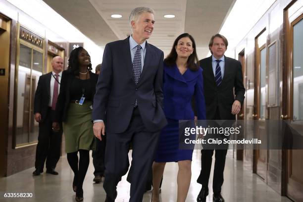 Supreme Court nominee Judge Neil Gorsuch is accompanied by former US senator Kelly Ayotte of New Hampshire as they arrive at the Dirksen Senate...