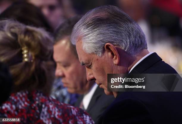 Rex Tillerson, U.S. Secretary of State, bows his head in prayer during the National Prayer Breakfast in Washington, D.C., U.S., on Thursday, Feb. 2,...