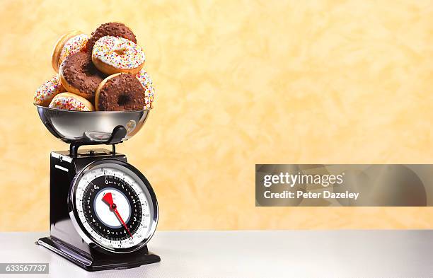 doughnuts on scales - köksvåg bildbanksfoton och bilder