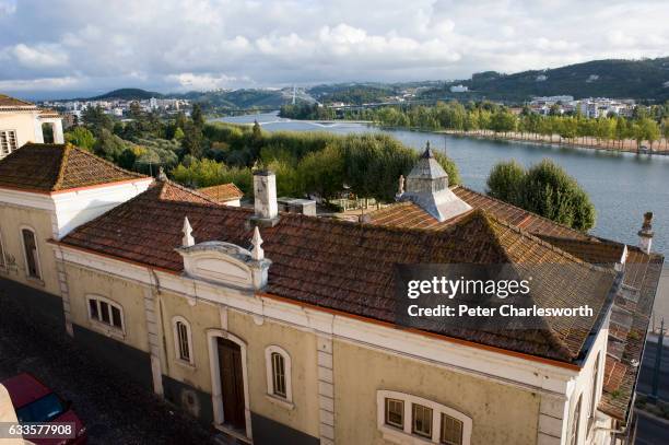View of rooftops of the old city looking down on the Mondego River in this famous old university town. The old university of Coimbra sits on top of...