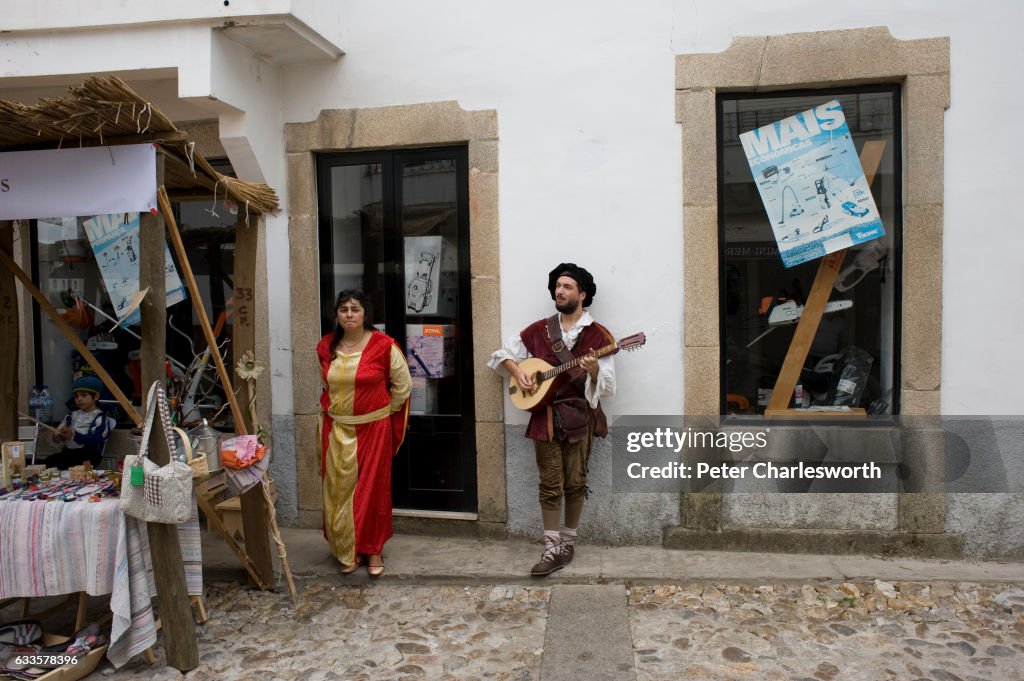 A wandering minstrel serenades an uninterested 'wench' at a...
