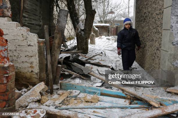 Young local resident of the flashpoint eastern town of Avdiivka that sits just north of the pro-Russian rebels' de facto capital of Donetsk, walks...