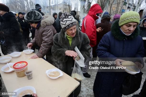 Social worker serve hot food to local residents in the flashpoint eastern town of Avdiivka, that sits just north of the pro-Russian rebels' de facto...