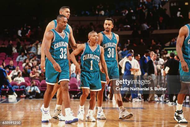 Muggsy Bogues, Dell Curry and LeRon Ellis of the Charlotte Hornets walk against the New York Knicks on January 2, 1994 at Madison Square Garden in...