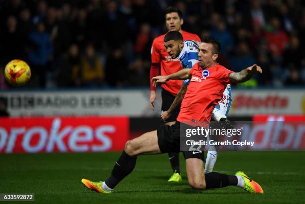 Nahki Wells of Huddersfield scores his team's second goal past Shane Duffy of Brighton during the Sky Bet Championship match between Huddersfield...