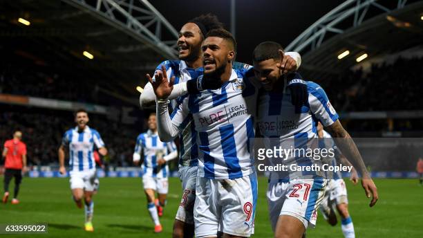 Elias Kachunga of Huddersfield celebrates with Isaiah Brown and Nahki Wells after scoring his team's 3rd goal during the Sky Bet Championship match...