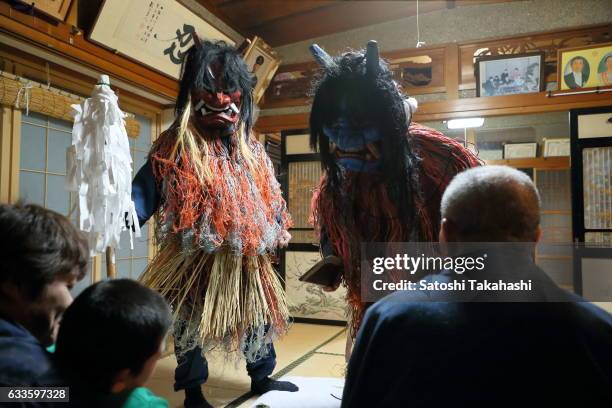 Namahage deities visiting a house during the Namahage festival of traditional folk event on New Year's Eve. They shouting loudly to people Are there...