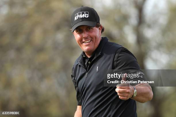 Phil Mickelson reacts after making his birdie putt on the ninth green during the first round of the Waste Management Phoenix Open at TPC Scottsdale...