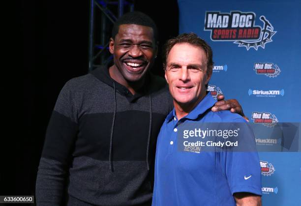Former NFL players Michael Irvin, left, and Doug Flutie visit the SiriusXM set at Super Bowl 51 Radio Row at the George R. Brown Convention Center on...