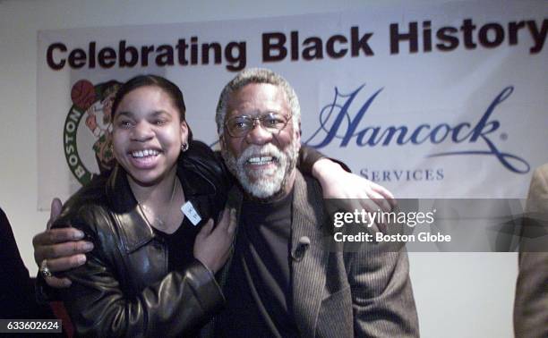 Desiree Mathis, a basketball player at Brighton High School, gets a hug from Celtics Hall of Famer Bill Russell at the FleetCenter during a panel...