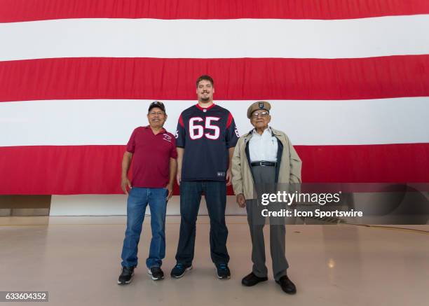 Houston Texans center Greg Mancz poses with retired Staff Sgt. Martin Sanchez and WWII veteran PVT First Class Marcos Barelas during the Super Bowl...