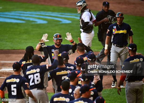 Jesus Flores of Aguilas del Zulia from Venezuela celebrates with teammates after scoring against Criollos de Caguas from Puerto Rico, during the...