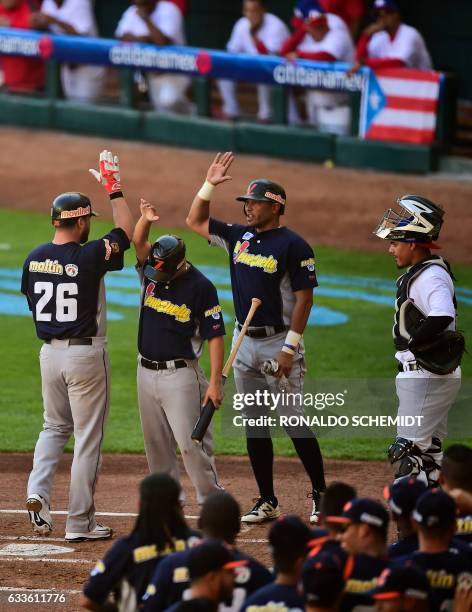 Jesus Flores of Aguilas del Zulia from Venezuela celebrates with teammates after scoring against Criollos de Caguas from Puerto Rico, during the...