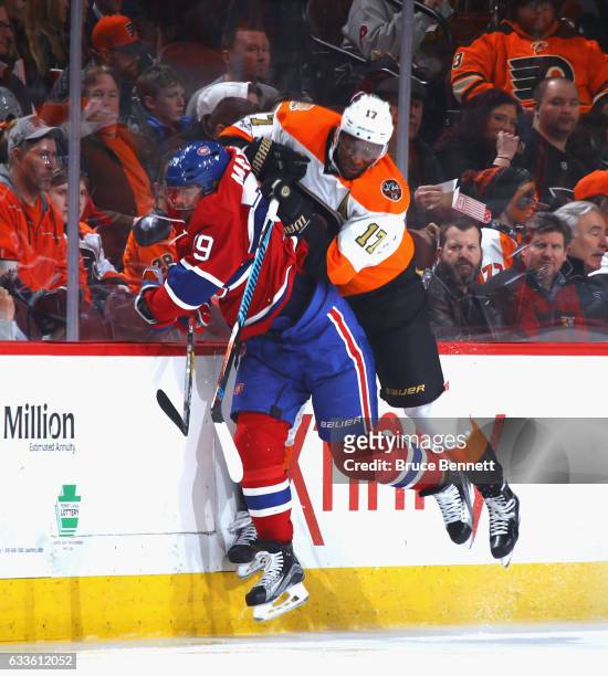 Wayne Simmonds of the Philadelphia Flyers checks Andrei Markov of the Montreal Canadiens during the second period at the Wells Fargo Center on...