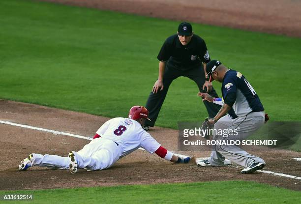 David Vidal of Criollos de Caguas from Puerto Rico slides safe into second base in a match against Aguilas del Zulia from Venezuela during the...