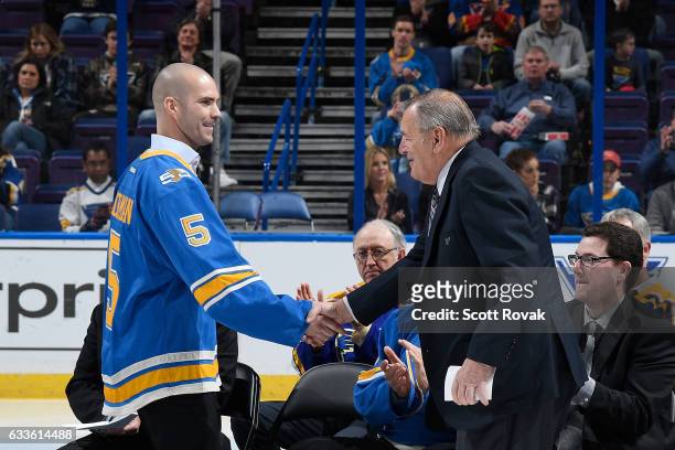 Barret Jackman shakes hands with Bob Plager during Plager's number retirement ceremony prior to a game between the Toronto Maple Leafs and the St....