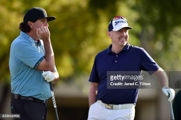 Pat Perez talks with Rod Pampling of Australia on the fifth tee box during the first round of the Waste Management Phoenix Open at TPC Scottsdale on...