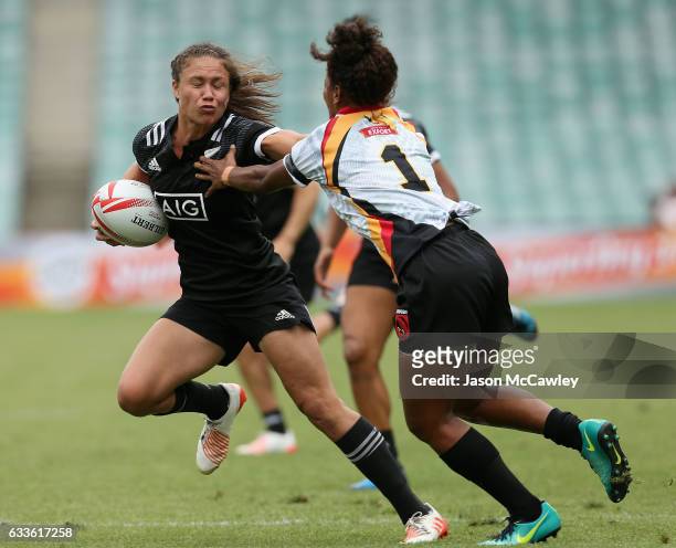 Ruby Tui of New Zealand puts a fend on Kymlie Rapilla of Papua New Guinea during the pool match between New Zealand and Papua New Guinea in the 2017...