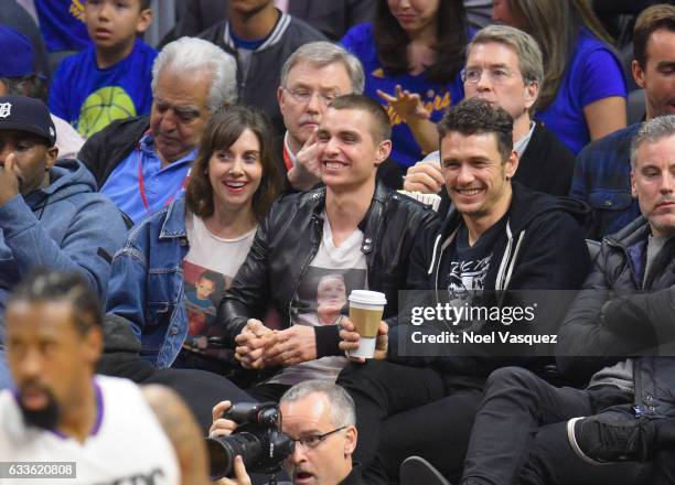 Alison Brie, Dave Franco and James Franco attend a basketball game between the Golden State Warriors and Los Angeles Clippers at Staples Center on...