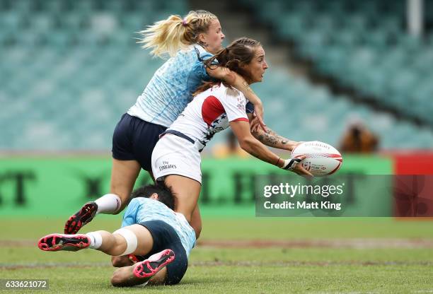 Ryan Carlyle of the USA offloads the ball in a tackle during the womens pool match between Russia and USA in the 2017 HSBC Sydney Sevens at Allianz...