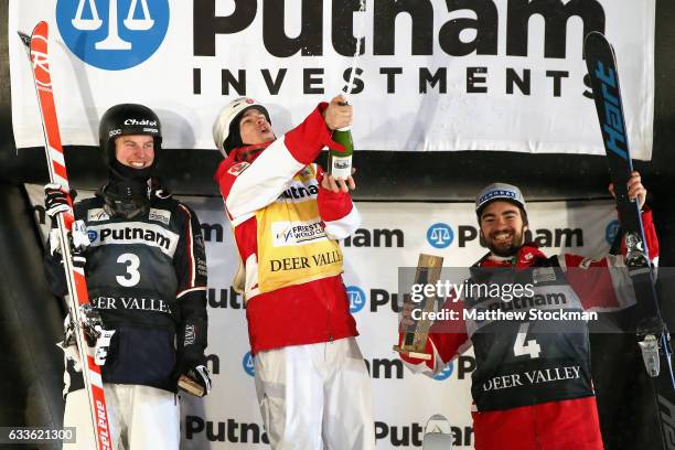 Benjamin Cavet of France, Mikael Kingsbury of Canada and Philippe Marquis of Canada celebrate on the medals podium after the Men's Moguls during the...