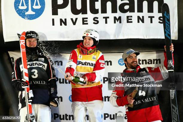 Benjamin Cavet of France, Mikael Kingsbury of Canada and Philippe Marquis of Canada celebrate on the medals podium after the Men's Moguls during the...
