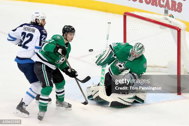 Kari Lehtonen of the Dallas Stars blocks a shot on goal against Chris Thorburn of the Winnipeg Jets and Antoine Roussel of the Dallas Stars defends...