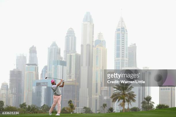 Lee Westwood of England plays his second shot into the 13th green during the second round of the Omega Dubai Desert Classic on the Majils Course at...