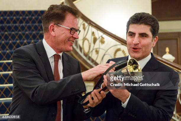 German Development Minister Gerd Mueller hands over a horn as official present to Nechirvan Barzani, Prime Minister of the Kurdish Government in...