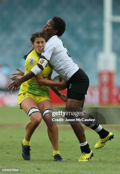 Charlotte Caslick of Australia is tackled by Raijieli Daveua of Fiji during the pool match between Australia and Fiji in the 2017 HSBC Sydney Sevens...