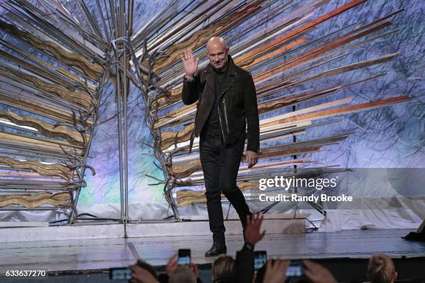 Designer John Varvatos greets the audience after his NYFW: Men's fashion show on February 2, 2017 in New York City.