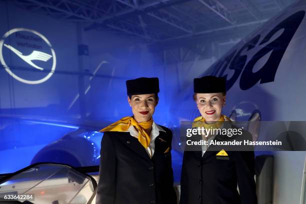 Airhostesses of German airline Lufthansa stands a the main door of Lufthansa's first Airbus A350-900 passenger plane during a roll-out event at...