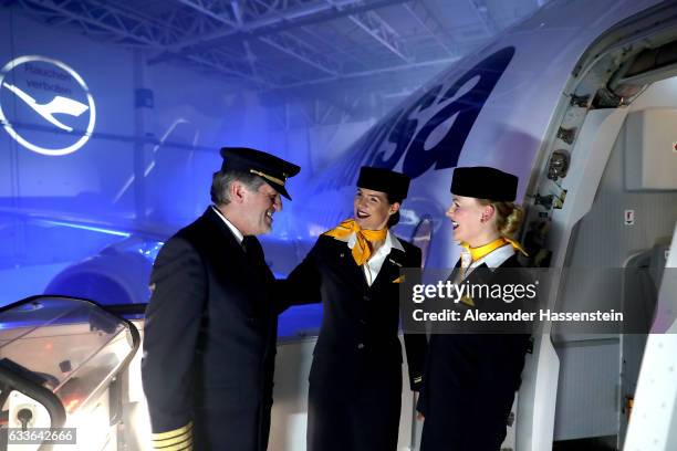 Airhostesses and a pilot of German airline Lufthansa stands a the main door of Lufthansa's first Airbus A350-900 passenger plane during a roll-out...