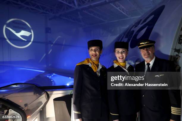 Airhostesses and a pilot of German airline Lufthansa stands a the main door of Lufthansa's first Airbus A350-900 passenger plane during a roll-out...