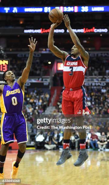 Washington Wizards guard Bradley Beal fires a three pointer over Los Angeles Lakers guard Nick Young at The Verizon Center in Washington, DC on...