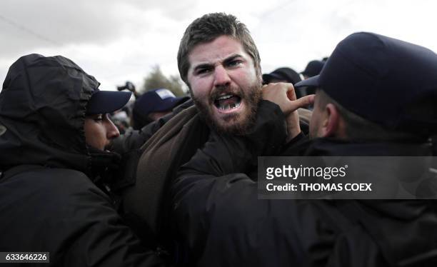 An Israeli settler scuffles with security forces at the Amona outpost, northeast of Ramallah, on February 1, 2017 as they evict the occupants of the...