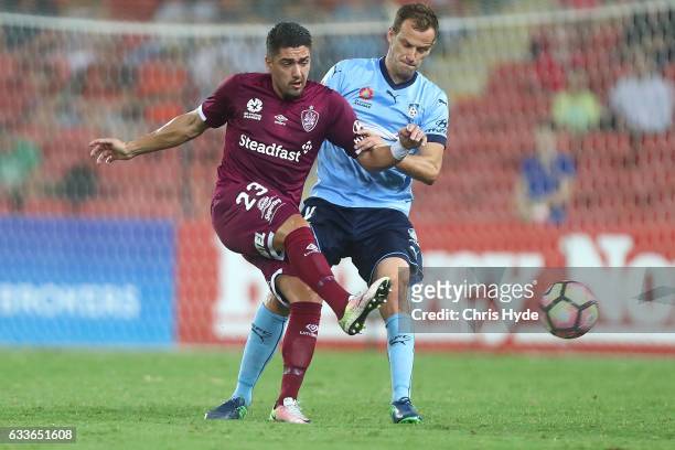 Dimitri Petratos of the Roar and Alexander Wilkinson of Sydney FC compete for the ball during the round 18 A-League match between the Brisbane Roar...