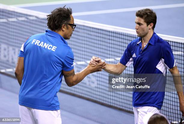 Captain of Team France Yannick Noah greets Gilles Simon of France following his victory against Yoshihito Nishioka of Japan on day 1 of the Davis Cup...