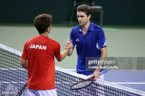 Gilles Simon of France greets Yoshihito Nishioka of Japan at the net following his victory on day 1 of the Davis Cup World Group first round tie...