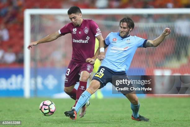 Dimitri Petratos of the Roar and Joshua Brillante of Sydney FC compete for the ball during the round 18 A-League match between the Brisbane Roar and...