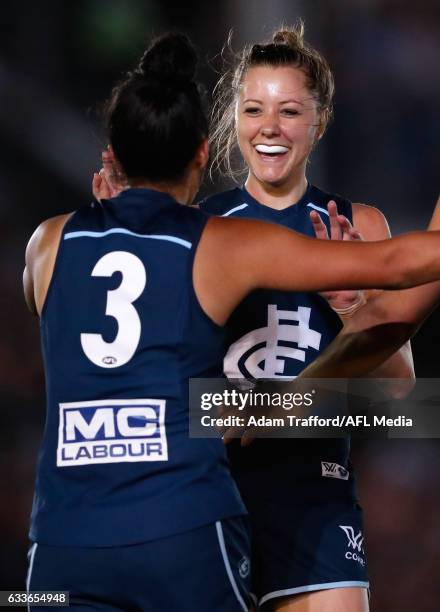 Bianca Jakobsson of the Blues congratulates Darcy Vescio of the Blues on a goal during the 2017 AFLW Round 01 match between the Carlton Blues and the...