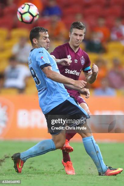 Matthew McKay of Roar and Bobo of Sydney FC compete for the ball during the round 18 A-League match between the Brisbane Roar and Sydney FC at...