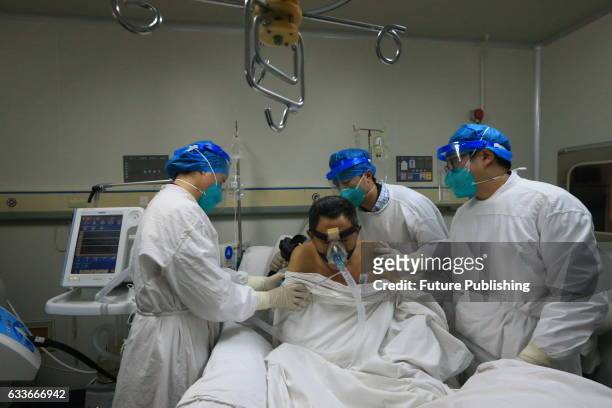 Medical staff help a patient infected by H7N9 bird flu on February 03, 2017 in Sichuan province, Suining, China. The health authority confirmed its...